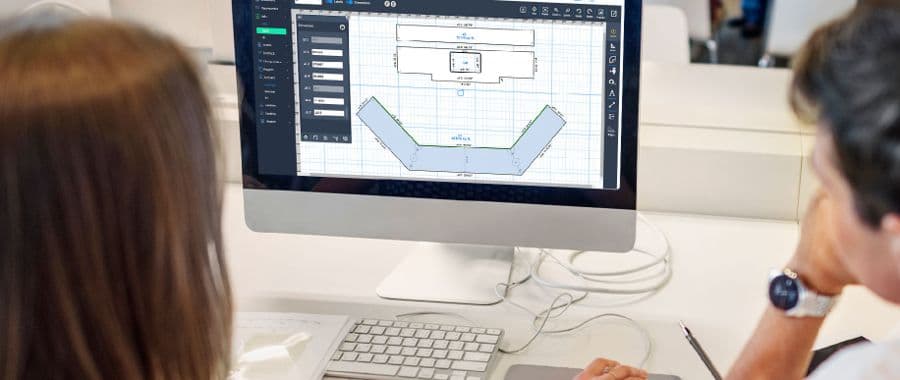 Two people reviewing a countertop layout in QXM Pro
